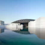 A general view of the exterior of the Louvre Abu Dhabi seen from the concrete beach area.